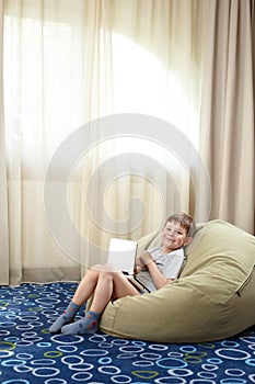 Little boy with laptop smiling