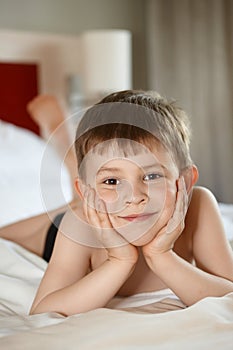 Little boy laying on bed