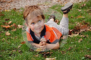 Little boy laying on the grass