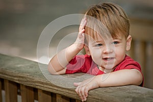 Little boy leaning on railing