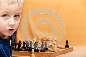 Little boy learn to play chess.