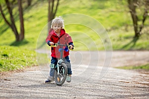 Little boy, learning how to ride a bike in the park