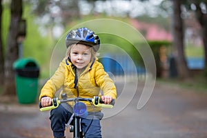 Little boy, learning how to ride a bike in the park