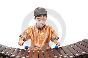 Little boy learning Thai instument Xylophone, Ranat, on white background
