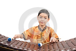 Little boy learning Thai instument Xylophone, Ranat, on white background