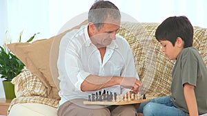 Little boy learning to play chess