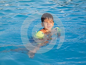 Little boy learning to swim