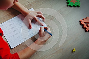 Little boy learning write and culculate numbers