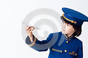 The little boy learns the profession of a pilot. He plays with toy airplane in the pilot`s uniform.