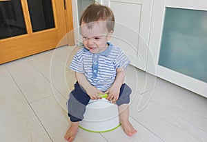 A little boy learns to go potty. Accustom the child to the potty