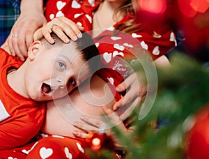 a little boy lies on the stomach of a pregnant mother. happy family