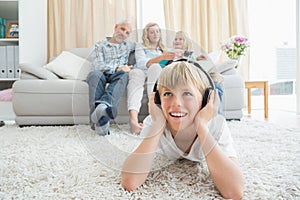 Little boy listening to music on the floor