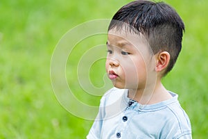 Little boy look at other side with funny face