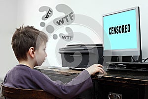 Little boy looking at computer with censored content.