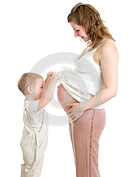 Little boy looking into pregnant mother's belly