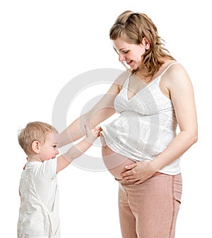 Little boy looking into pregnant mother's belly