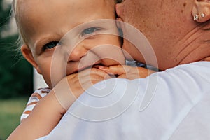 Little boy looks over his mother& x27;s shoulder.