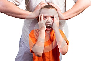 A little boy looks at the phone, and is surprised. Isolated on a blue background