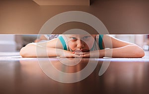 Little boy looks under the bed