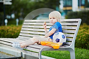 Little boy with lunchbox and healthy snack