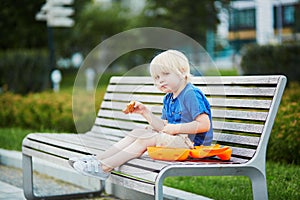 Little boy with lunchbox and healthy snack