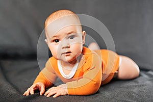 Little boy is lying and looking at the camera. Portrait of a newborn baby
