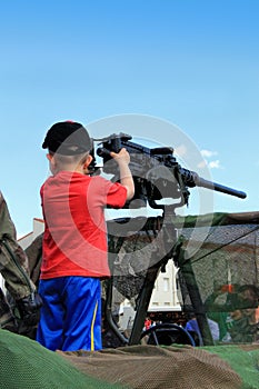 Little boy with machine gun