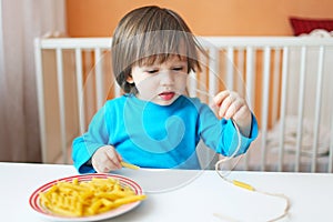 Little boy made macaroni beads