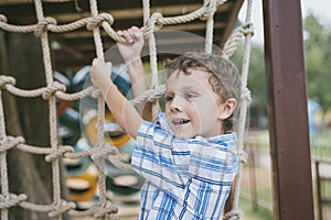 Little boy make climbing in the adventure park