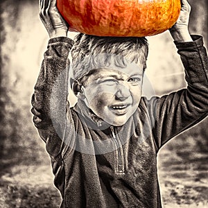 Little boy making a face with heavy pumpkin hat