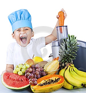 Little boy making fruit juice