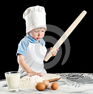Little boy making pizza or pasta dough