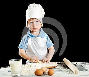 Little boy making pizza or pasta dough