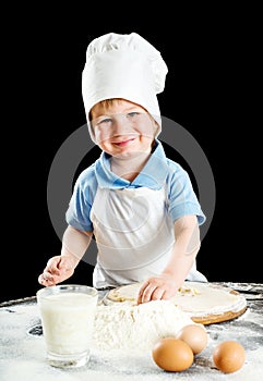 Little boy making pizza or pasta dough