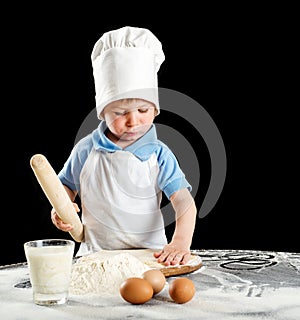 Little boy making pizza or pasta dough