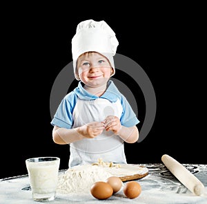 Little boy making pizza or pasta dough
