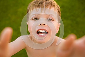 Little boy making selfie on the grass