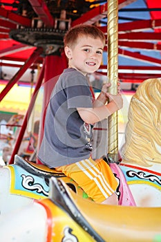 Little boy on a Merry go Round