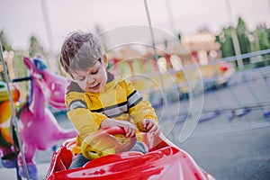 Little boy on the merry-go-round