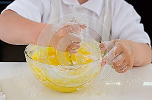 Little boy mixing cake ingredients