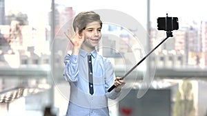 Little boy with monopod on blurred background.