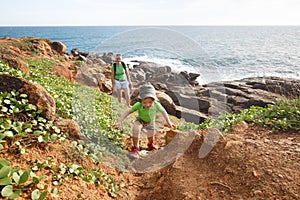 Little boy with mother on a family hike by the tropical sea