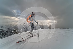 Little boy with mountaineering skis going uphill