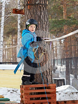 Little boy mountaineering in winter