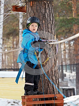 Little boy mountaineering in winter