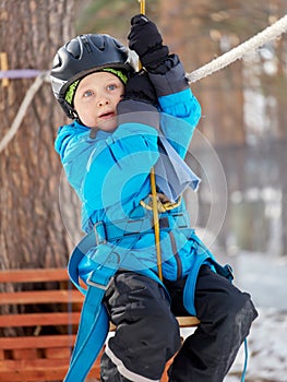 Little boy mountaineering in winter