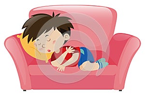 Little boy napping on pink sofa photo