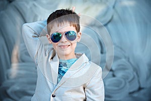 Little boy in a nice suit and glasses. Children portrait