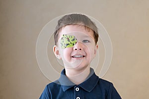 Little boy with okluder on the eye