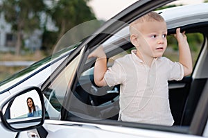 Little boy in an open car door